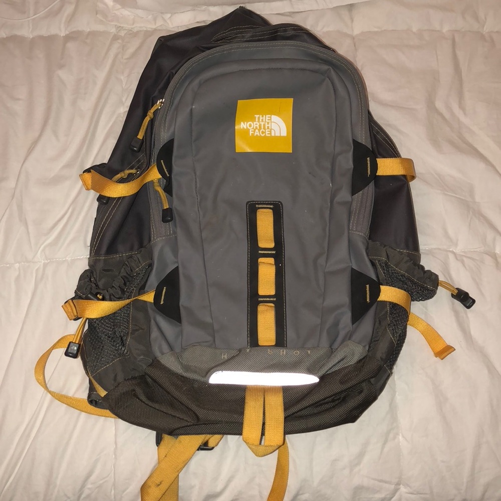 Gray and yellow North Face backpack